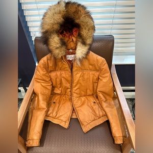 Leather jacket with fur trimmed hood.